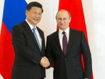 Xi Jinping-a la izquierda-y Vladimir Putin