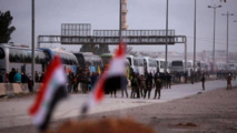 Los autobuses que llevarán a los milicianos al norte de Siria.