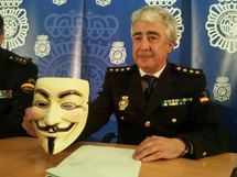 Un policía español muestra la máscara utilizada como símbolo por los miembros de Anonymous. Un policía español muestra la máscara utilizada como símbolo por los miembros de Anonymous.