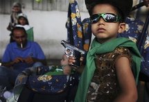 Un niño libio muestra un arma, durante la manifestación en Trípoli.