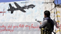 Un miliciano huthi mira a un mural que pregunta ¿porqué has matado a mi familia? a los aviones sin piloto estadounidenses Un miliciano huthi mira a un mural que pregunta ¿porqué has matado a mi familia? a los aviones sin piloto estadounidenses