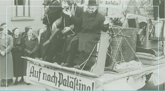 Un camión que lleva a judíos con un cartel donde se lee "¡A Palestina!" en Alemania en los años 1930