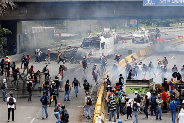 Manifestantes y policías en Caracas